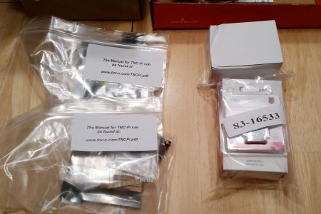 Two TNC-Pi kits from Coastal Chipworks and a Raspberry Pi development kit await further unpacking.